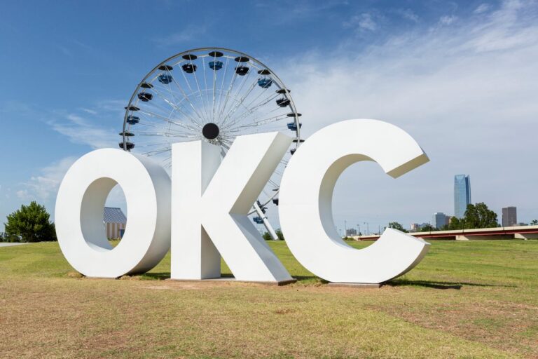 OKC sign in front of the Ferris wheel in the background.