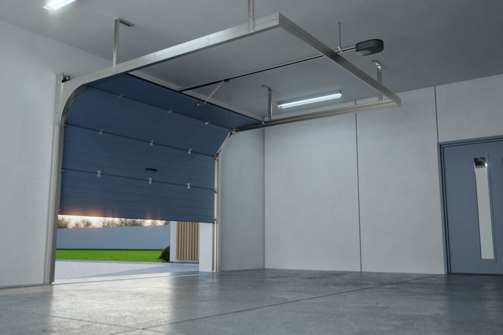 A home garage that is well-cleaned and free from clutter, featuring a blue roll-up garage door.