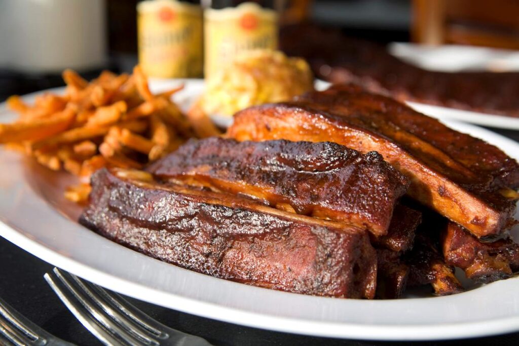 Kansas City-style ribs plated with French fries on the side